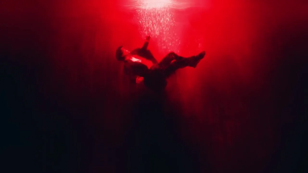 A figure falling through red light in a Silver Pines dream sequence